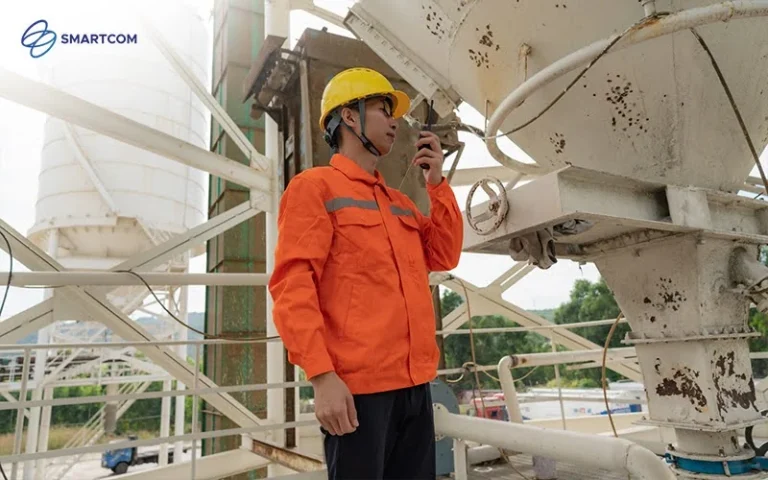 Contractor using a walkie-talkie to communicate