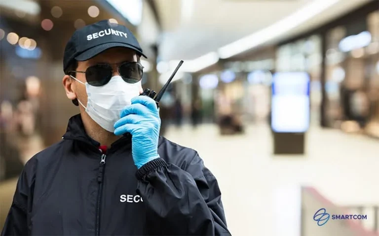 A security officer communicating with a walkie-talkie