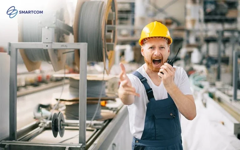 A construction worker speaking into a walkie-talkie